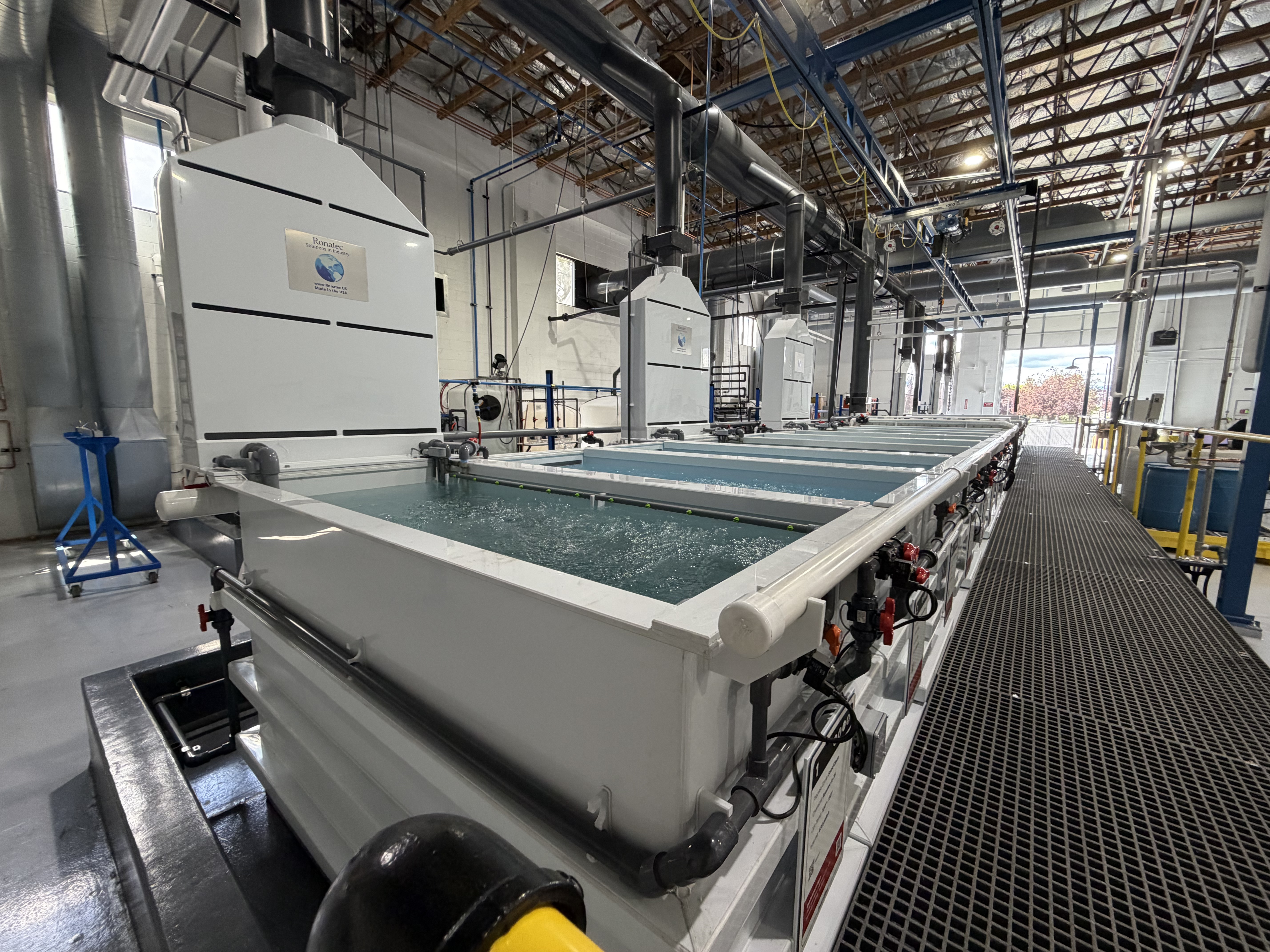 Modern Ronatec plating process line with tanks, ventilation hoods, and working platforms